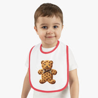 Toddler wearing Printify eco-friendly baby bib with red trim and teddy bear cookie design