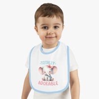Toddler wearing a Printify eco-friendly baby bib with blue trim and adorable elephant design