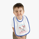 Toddler wearing Printify eco-friendly baby bib with cute elephant design and blue trim