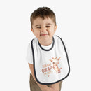 Toddler wearing Printify eco-friendly baby bib with cute giraffe design and text You Bet Giraffe I'm Cute