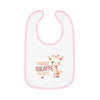 Printify eco-friendly baby bib with pink trim featuring a cute giraffe and text You Bet Giraffe I'm Cute
