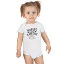 Baby wearing a white eco-friendly baby onesie with worlds cutest alarm clock print
