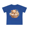 Printify eco-friendly baby t-shirt in blue with teddy bear in basket and floral design