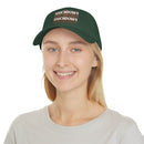 Printify eco-friendly baseball cap in dark green with touchdown text worn by smiling woman