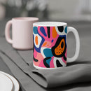 Printify eco-friendly ceramic mugs with colorful abstract design placed on gray fabric