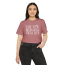 Woman wearing a mauve eco-friendly fashion tee with The New Beginnings Social Club print from Printify