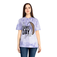 Woman wearing a Printify eco-friendly game day t-shirt with a purple tie-dye design and football graphic