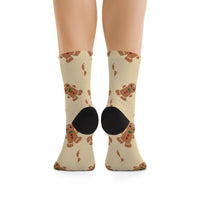 Eco-friendly ginger snaps socks by Printify featuring a beige background with gingerbread man patterns