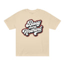 Printify beige eco-friendly graphic tee with Busy Doing Nothing bold white and black text design