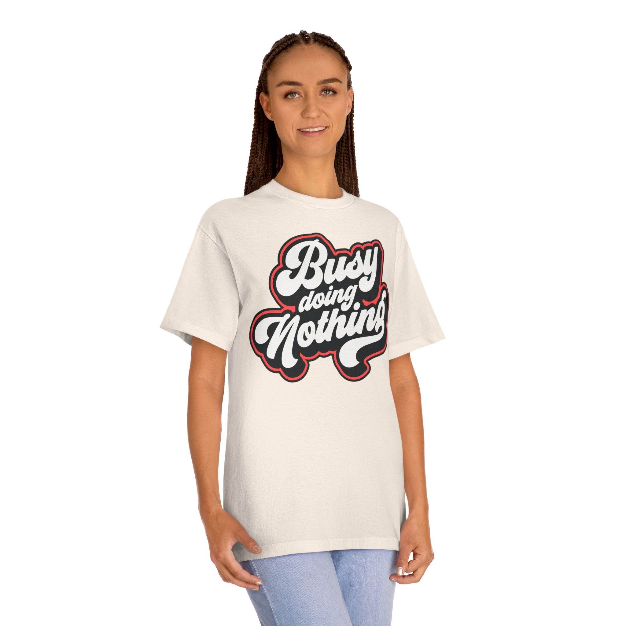 Printify eco-friendly graphic tee in white with Busy Doing Nothing text worn by a smiling woman