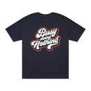 Printify black eco-friendly graphic tee with Busy Doing Nothing white and red text design