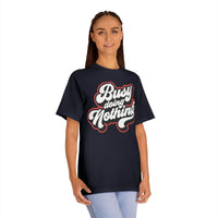 Printify eco-friendly graphic tee in black with busy doing nothing slogan worn by woman