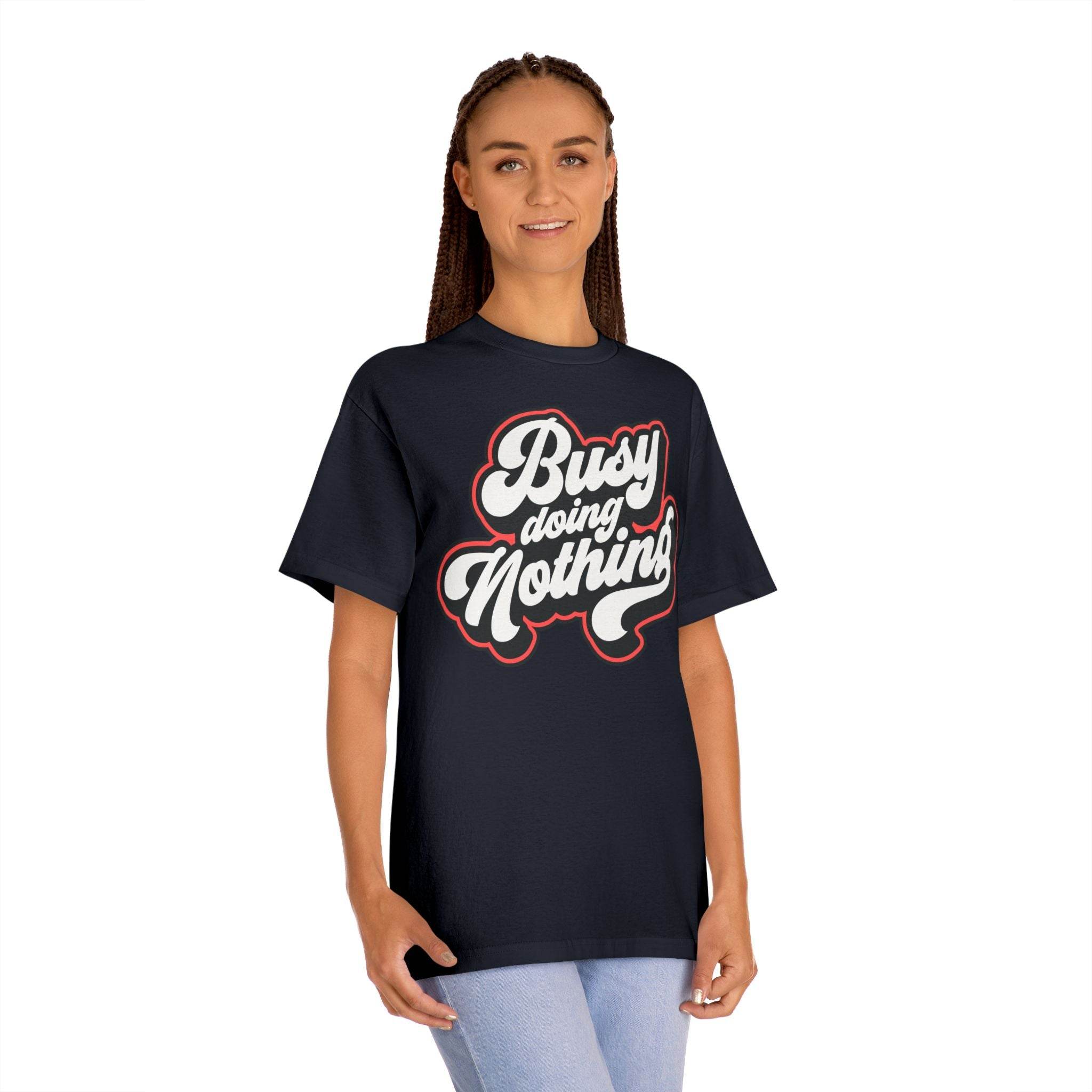 Printify eco-friendly graphic tee in black with busy doing nothing slogan worn by woman