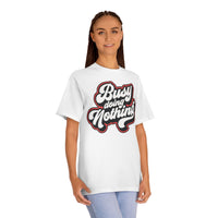 Printify white eco-friendly graphic tee with Busy Doing Nothing text worn by woman