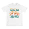 Printify white eco-friendly graphic tee with colorful retro text saying I don't know how to act my age