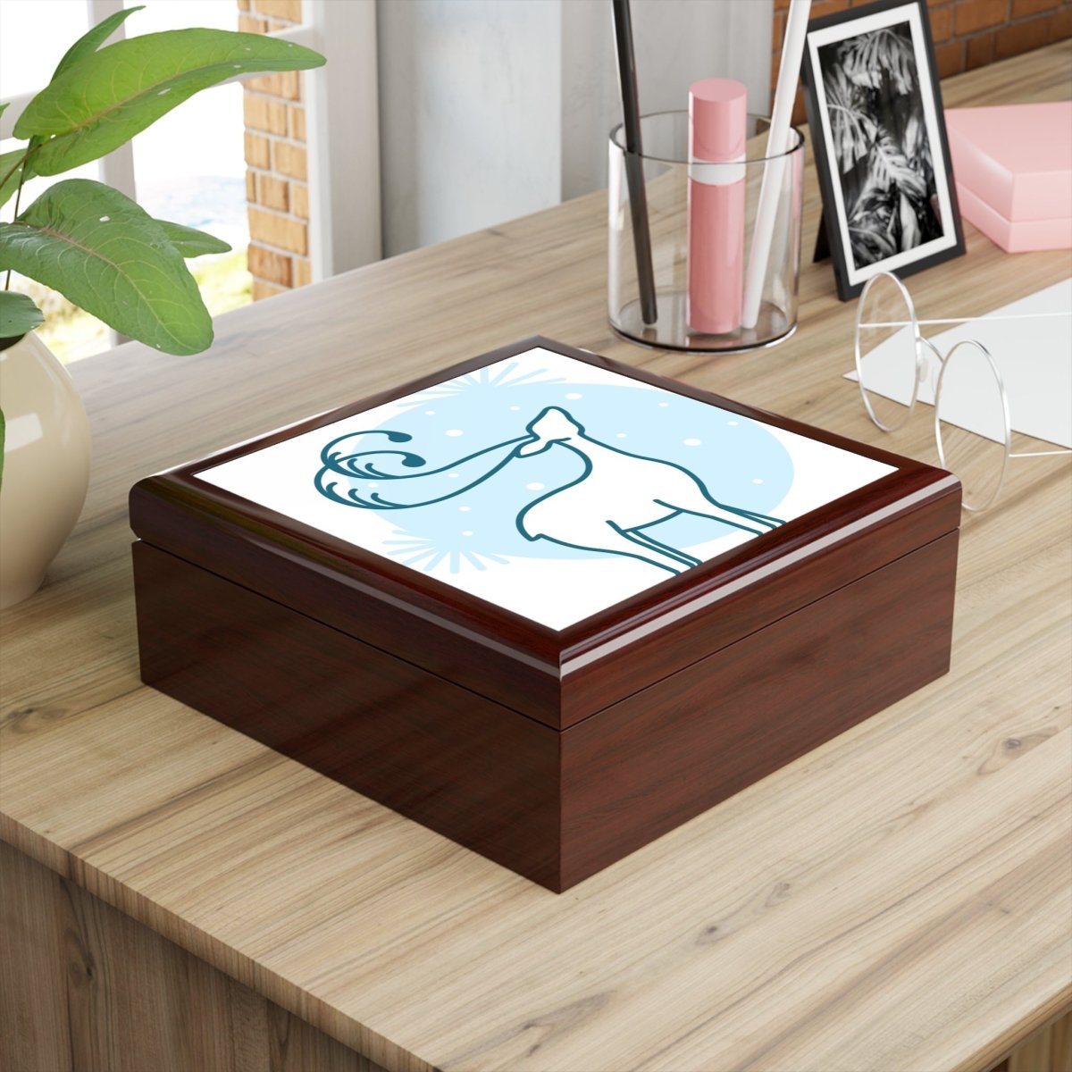 Elegant eco-friendly jewelry box with artistic design on a wooden surface in a bright workspace