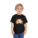 Printify black eco-friendly kids t-shirt with cute animal design worn by smiling toddler