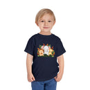 Young boy wearing a Printify eco-friendly kids t-shirt with cute animal print design