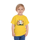Printify eco-friendly kids t-shirt in yellow with cute animal graphic worn by a smiling toddler
