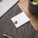Printify eco-friendly note pads with heart design on white paper placed on desk near laptop and plant