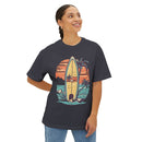 Printify eco-friendly oversized t-shirt with vintage surfboard and palm tree graphic worn by smiling woman