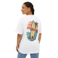 Printify eco-friendly oversized t-shirt white with surfboard and beach graphic on back worn by smiling woman