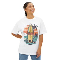 Woman wearing a Printify eco-friendly oversized t-shirt with a surfboard and tropical sunset graphic