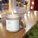 Printify eco-friendly scented candles lit in a glass jar on a wooden surface near holiday decorations