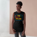 Woman wearing a black eco-friendly tank top with colorful The Beach is Calling graphic from Printify