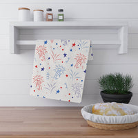 Printify eco-friendly tea towels with red and blue firework and star design hanging on white wooden rack