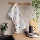 Colorful Printify eco-friendly tea towels hanging in a modern kitchen setting