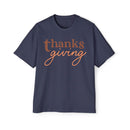Printify navy blue eco-friendly Thanksgiving shirt men with brown and orange thanksgiving text