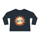 Printify eco-friendly toddler long sleeve shirt in black with cute sun wearing sunglasses graphic