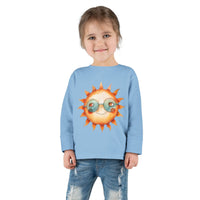Printify eco-friendly toddler long sleeve shirt in light blue with sun graphic worn by smiling toddler