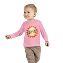 Toddler wearing a pink eco-friendly toddler long sleeve shirt with a sun graphic and sunglasses design