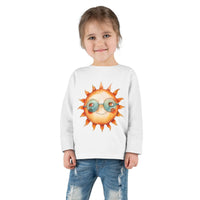 Smiling toddler wearing Printify eco-friendly toddler long sleeve shirt with sun graphic and sunglasses