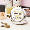 Printify eco-friendly travel mirror with inspirational text, surrounded by makeup brushes and cosmetics