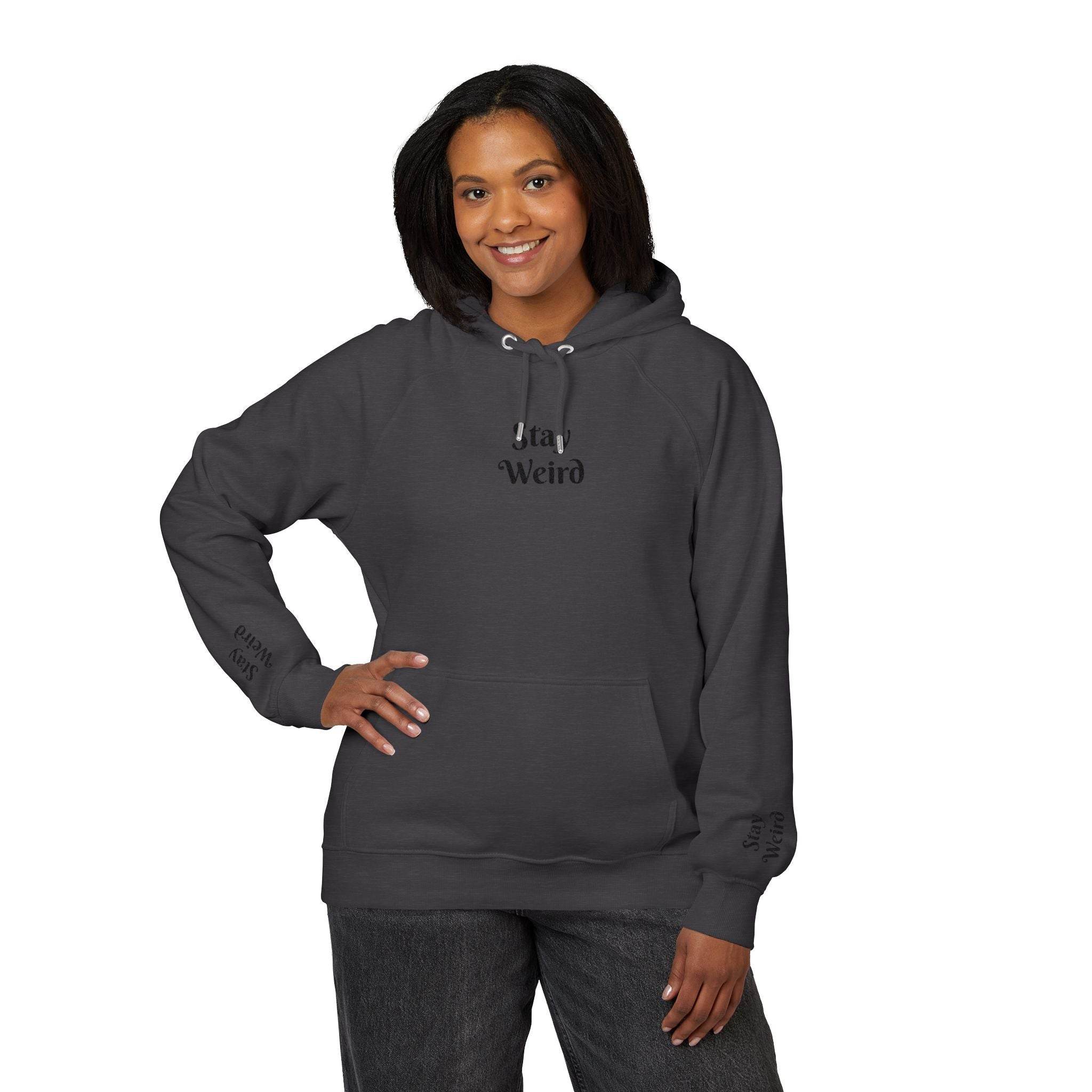 Printify eco friendly unisex hoodie in dark gray with stay weird text worn by smiling woman