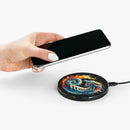 Hand placing smartphone on Printify eco-friendly wireless charger with colorful dragon design