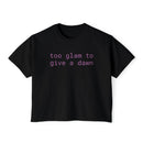 Black eco-friendly women's graphic tee from Printify with purple text reading too glam to give a dawn