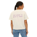 Printify eco-friendly women's graphic tee in cream with purple text saying too glam to give a dawn