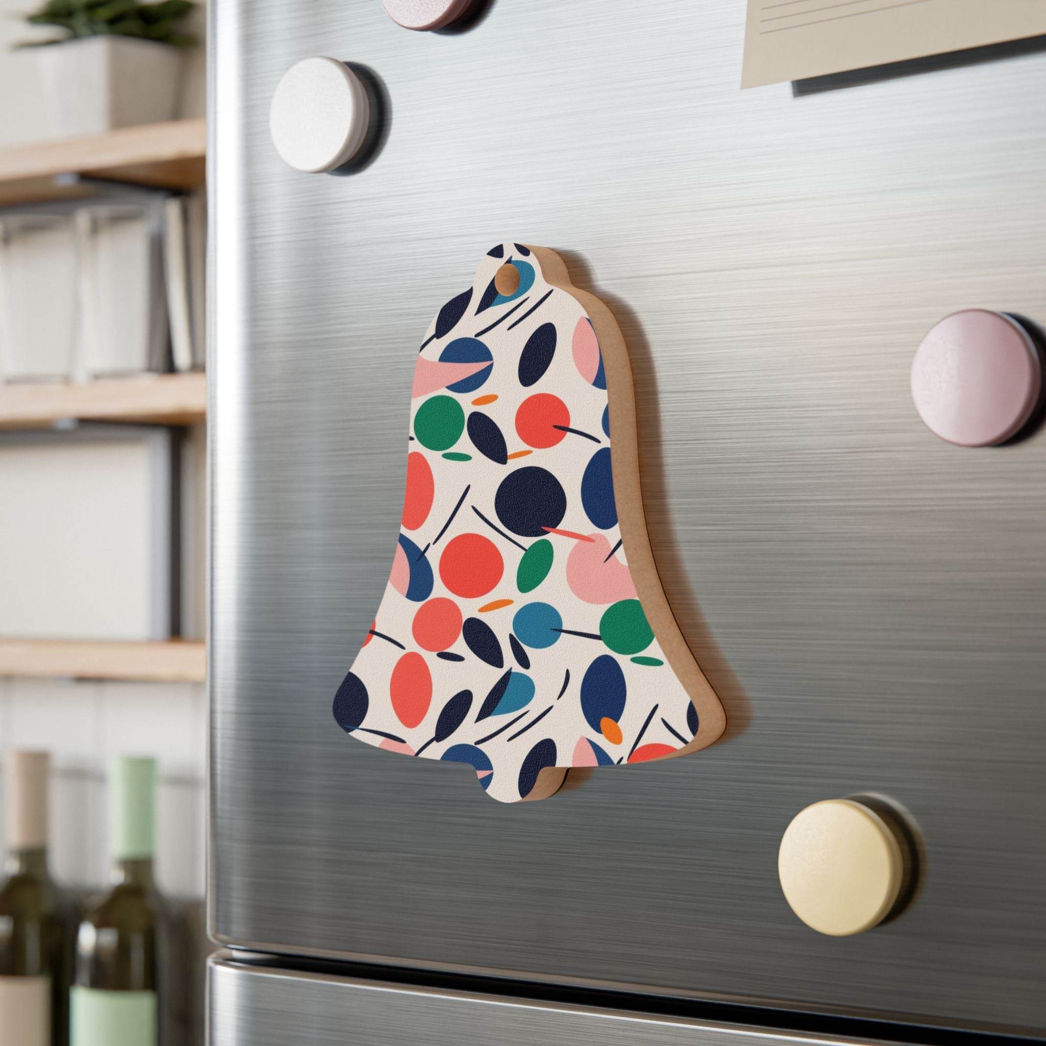 Printify eco-friendly wooden ornaments bell shaped with colorful abstract leaf pattern on fridge