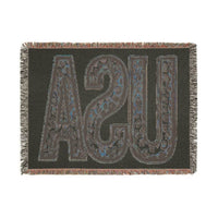 Printify eco-friendly woven blanket with dark background and large textured UPS letters design