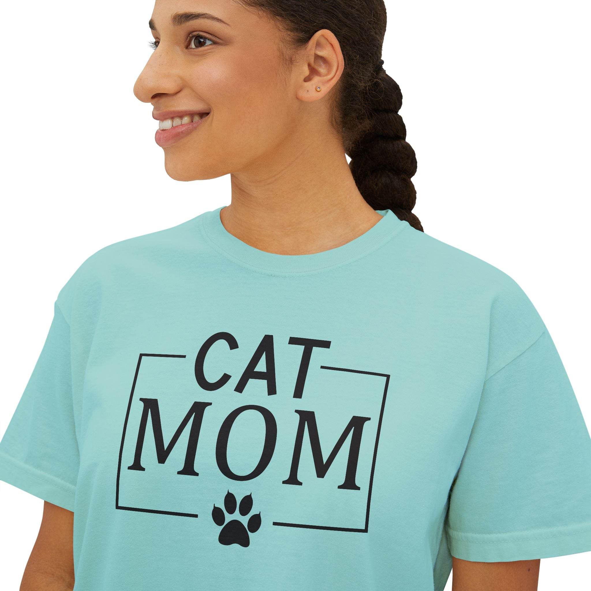 Printify eco-friendly cat mom shirt on smiling woman in seafoam T-shirt with black CAT MOM text and paw print