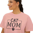 Smiling woman wearing Printify eco-friendly cat mom shirt pink tee with black CAT MOM text and paw print