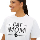 Smiling woman wearing Printify eco-friendly cat mom shirt white tee with black CAT MOM text and paw graphic