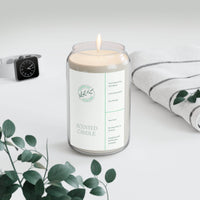 Printify eco-friendly scented candle lit in clear glass jar with natural label and white towel nearby
