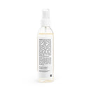 Clear spray bottle of natural face toner for sensitive skin with white label and pump dispenser