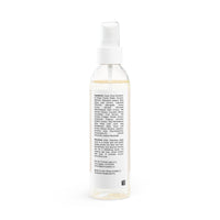 Clear spray bottle of natural face toner for sensitive skin with white label and pump dispenser