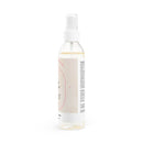 Clear spray bottle of natural face toner for sensitive skin with white cap and label by Printify